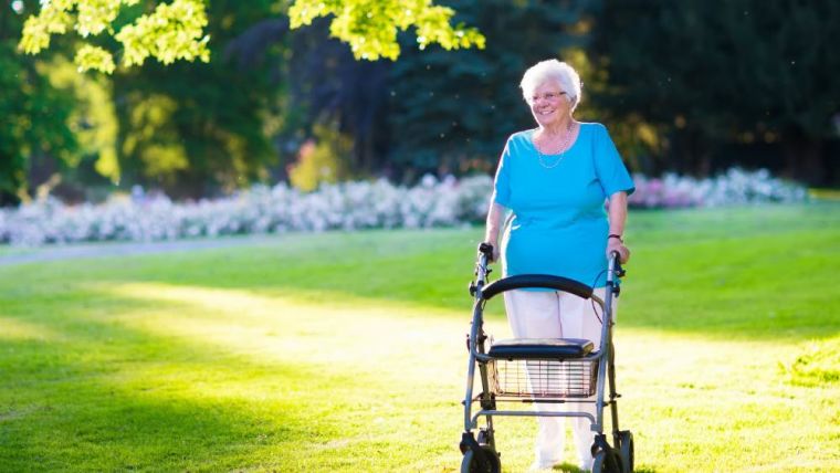 older woman uses walker outside